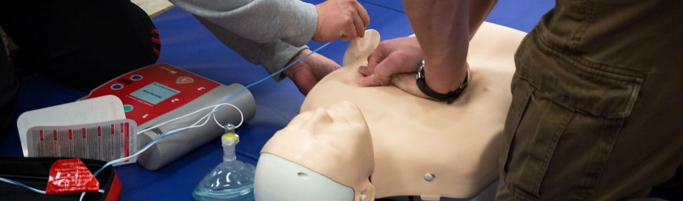 Students practicing CPR and defibrillator techniques