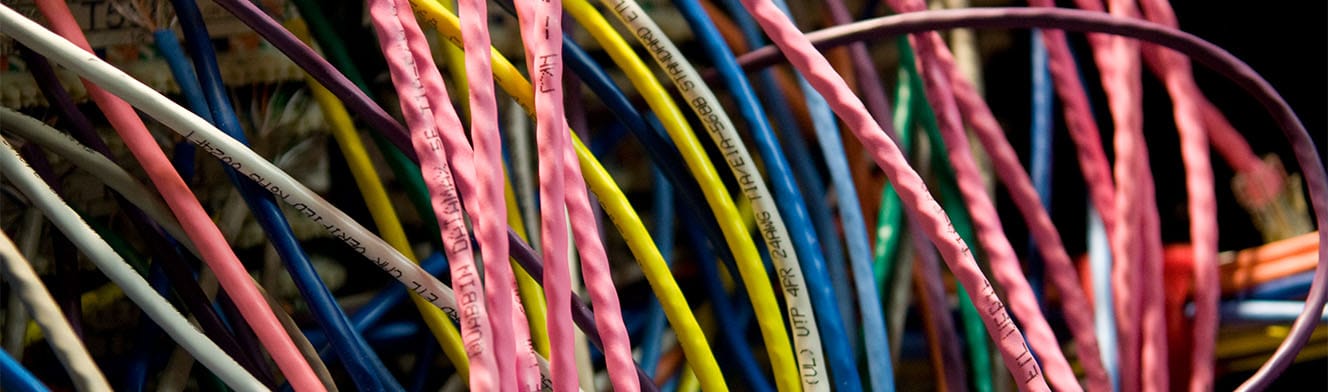 Closeup of network cables in various colors.