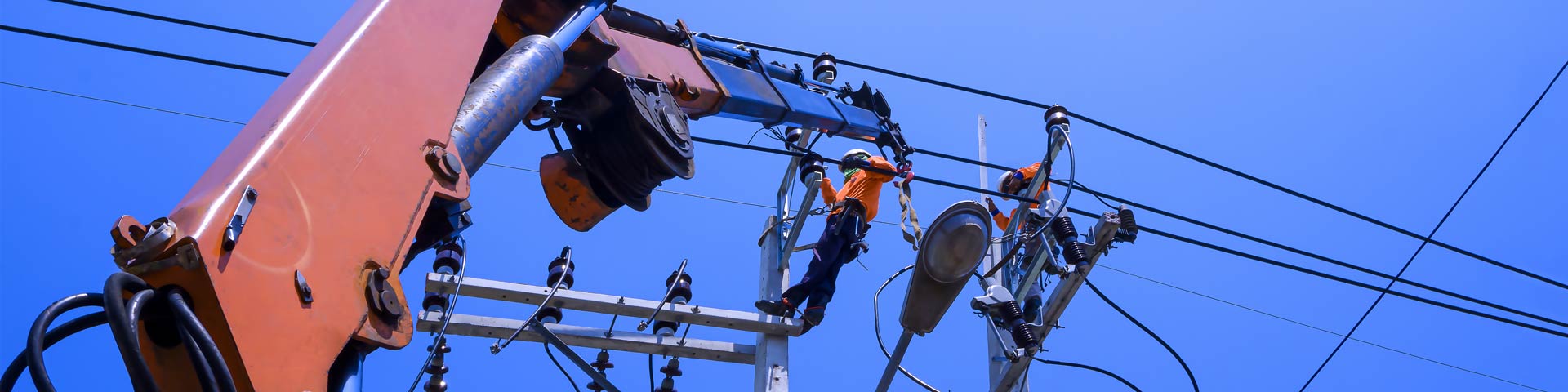 Two lineworkers making repairs to electric lines