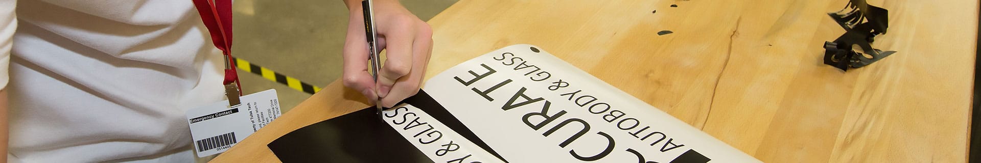 A student works on a custom sign.