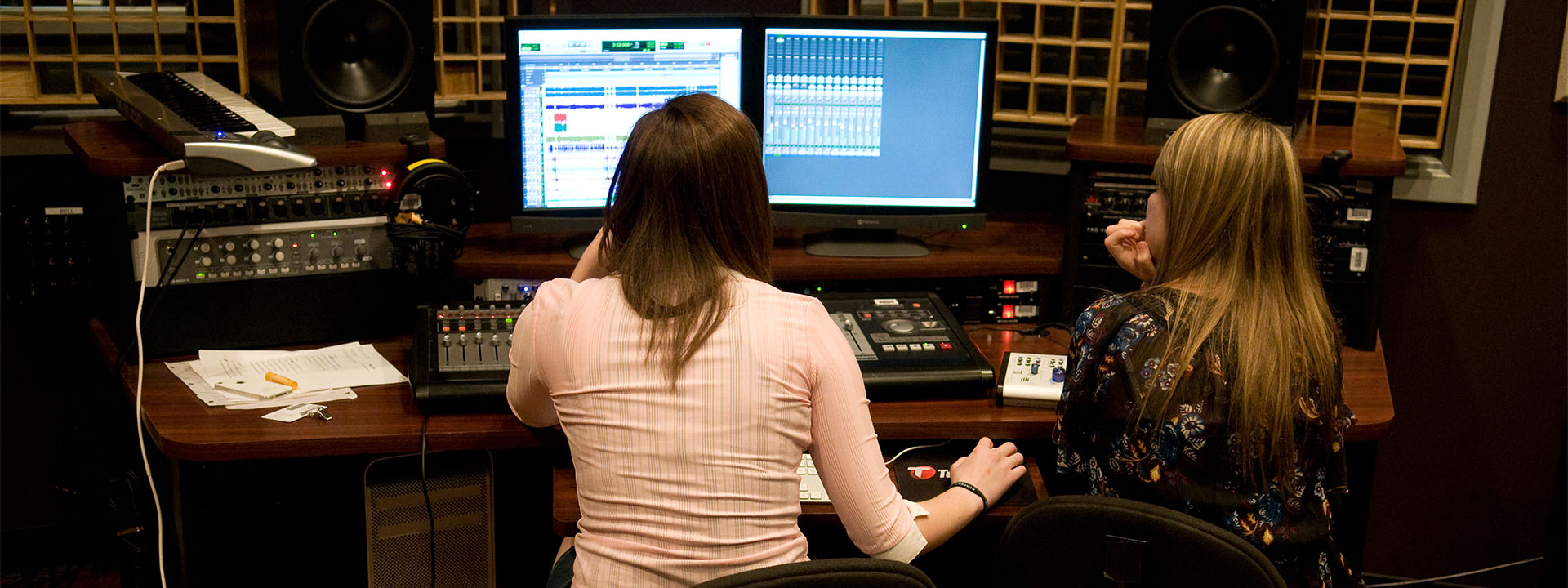 A student using a sound control board