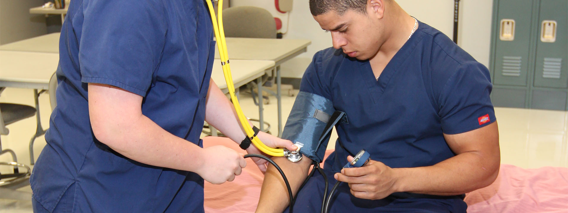 Students practicing measuring blood pressure