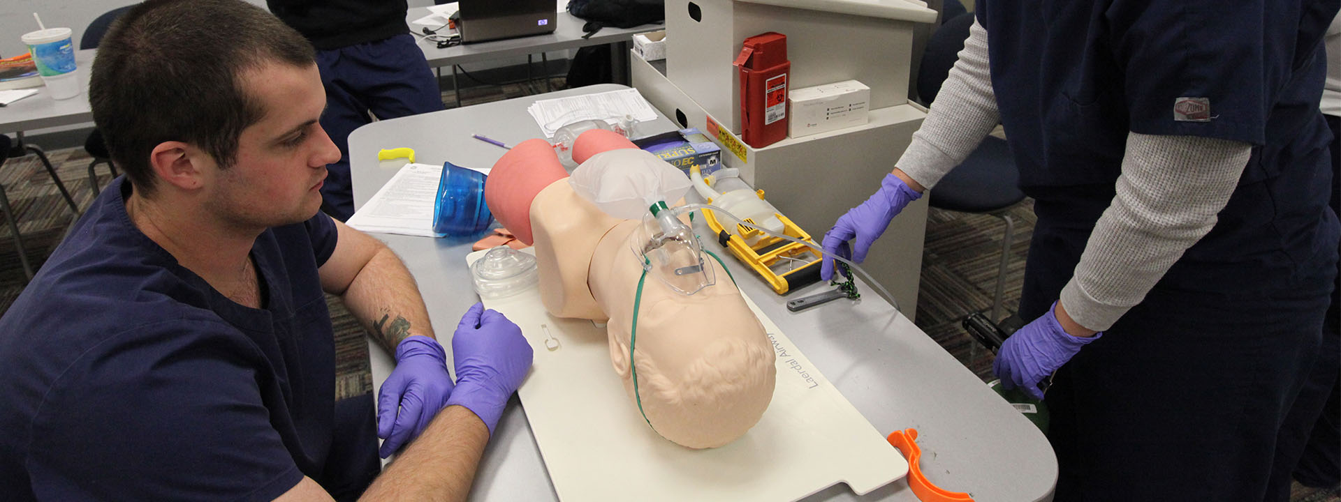 Students practice delivering oxygen to a mannequin