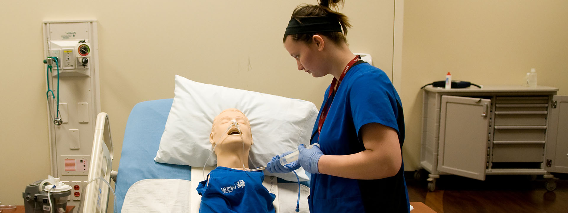 Student providing fluid to a mannequin