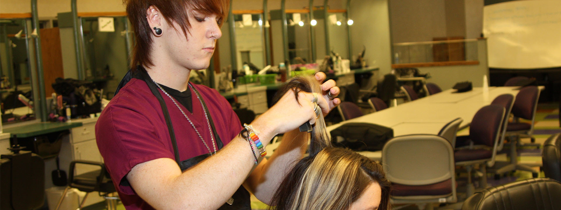 A student combs a client's hair