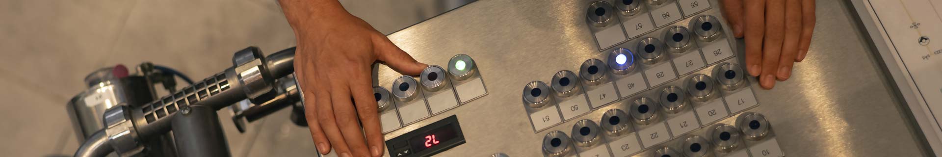 Hands of a machine operator as they run a piece of equipment