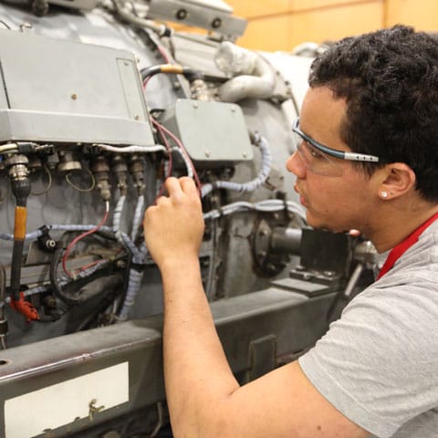 Student works on aircraft engine