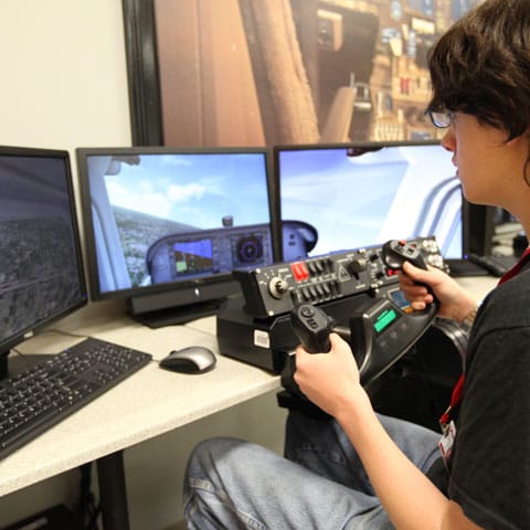 Student practices on a flight simulator