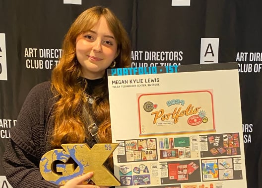 Lewis Megna holds her fist place winning portfolio at the Art Directors Club of Tulsa