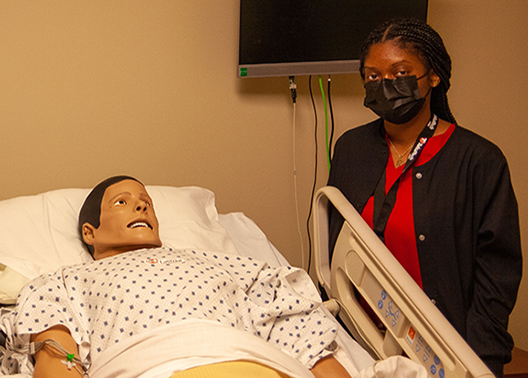 Student in health care simulation lab